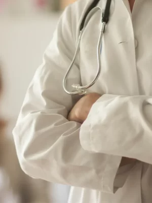 DrGhobadian-a-doctor-stands-ready-in-the-foreground-with-a-pat