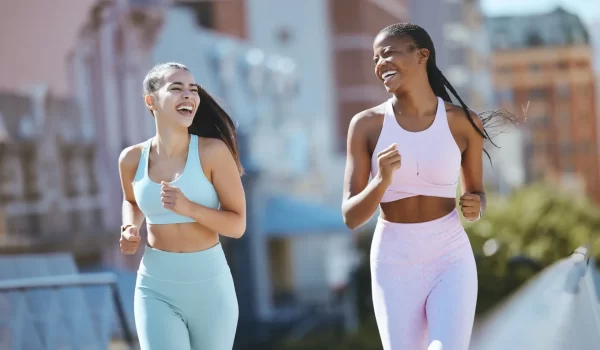 Fitness, women and city friends running in street on summer morning in Brazil. Health, urban exerci