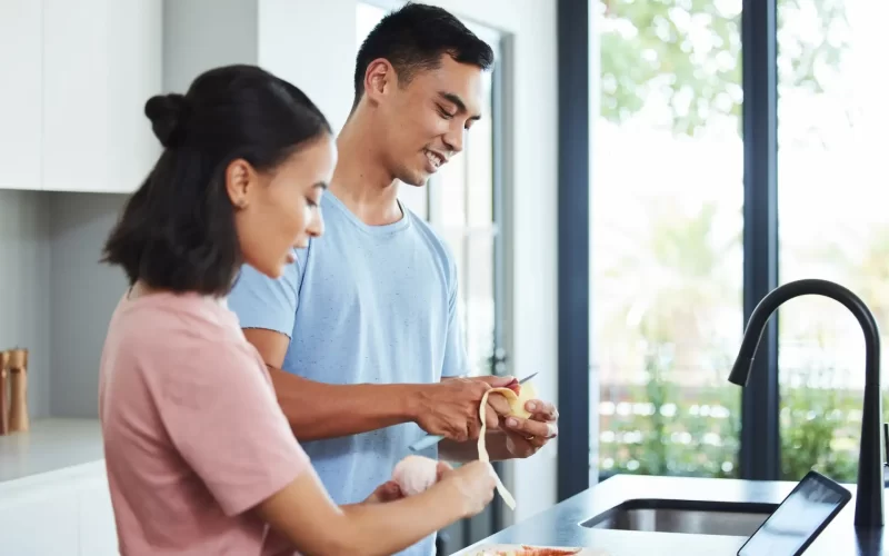 Pump your diet full of fruits. Shot of a young couple cooking together.